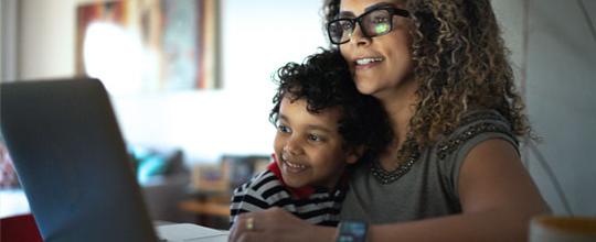 Mother and child browsing a computer together